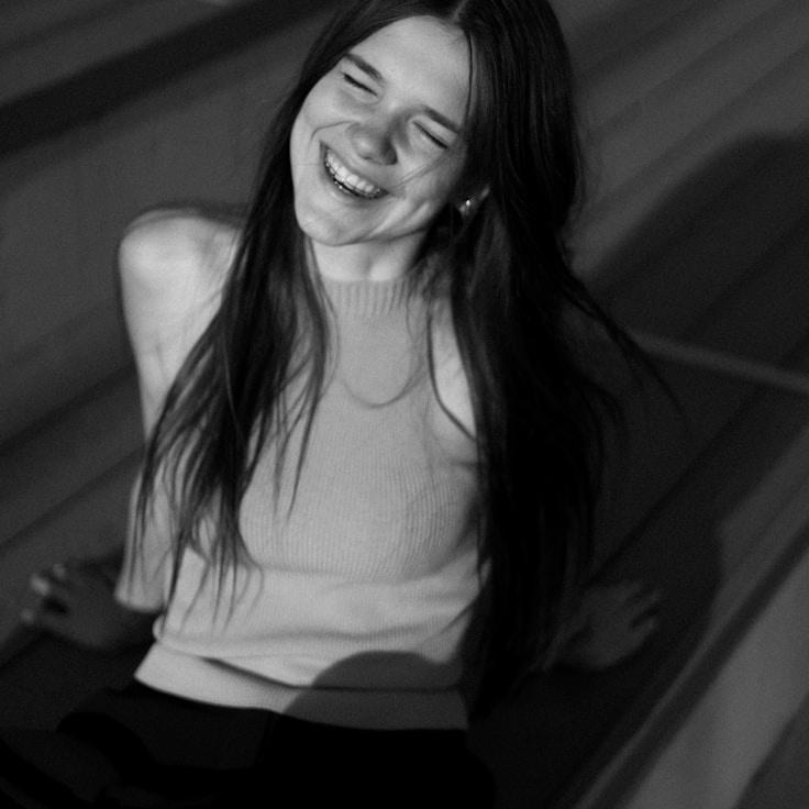 Asha Desai, Lead Design Curator at GrandBridgeSeek, reviewing corporate floral arrangements